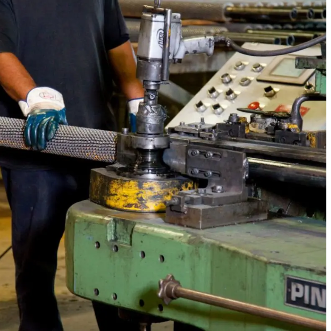 Worker making a finned tube