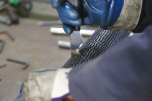 man checking measurement on heat exchanger tubes