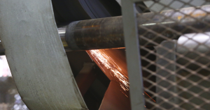 Close-up of a skilled welding on industrial fin tubes, showcasing precision welding techniques used by Tulsa Fin Tube